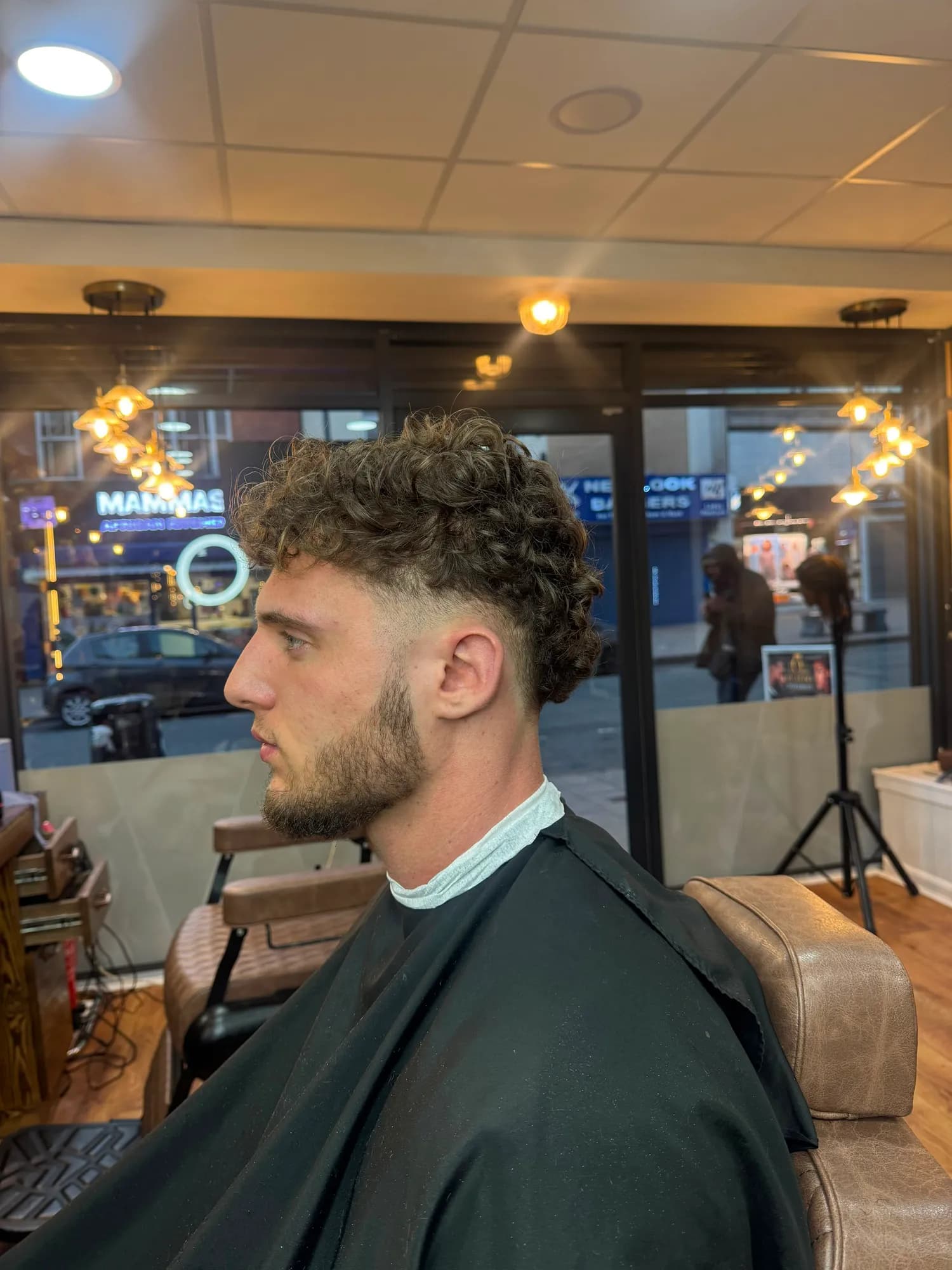 Men's curly top with a skin fade