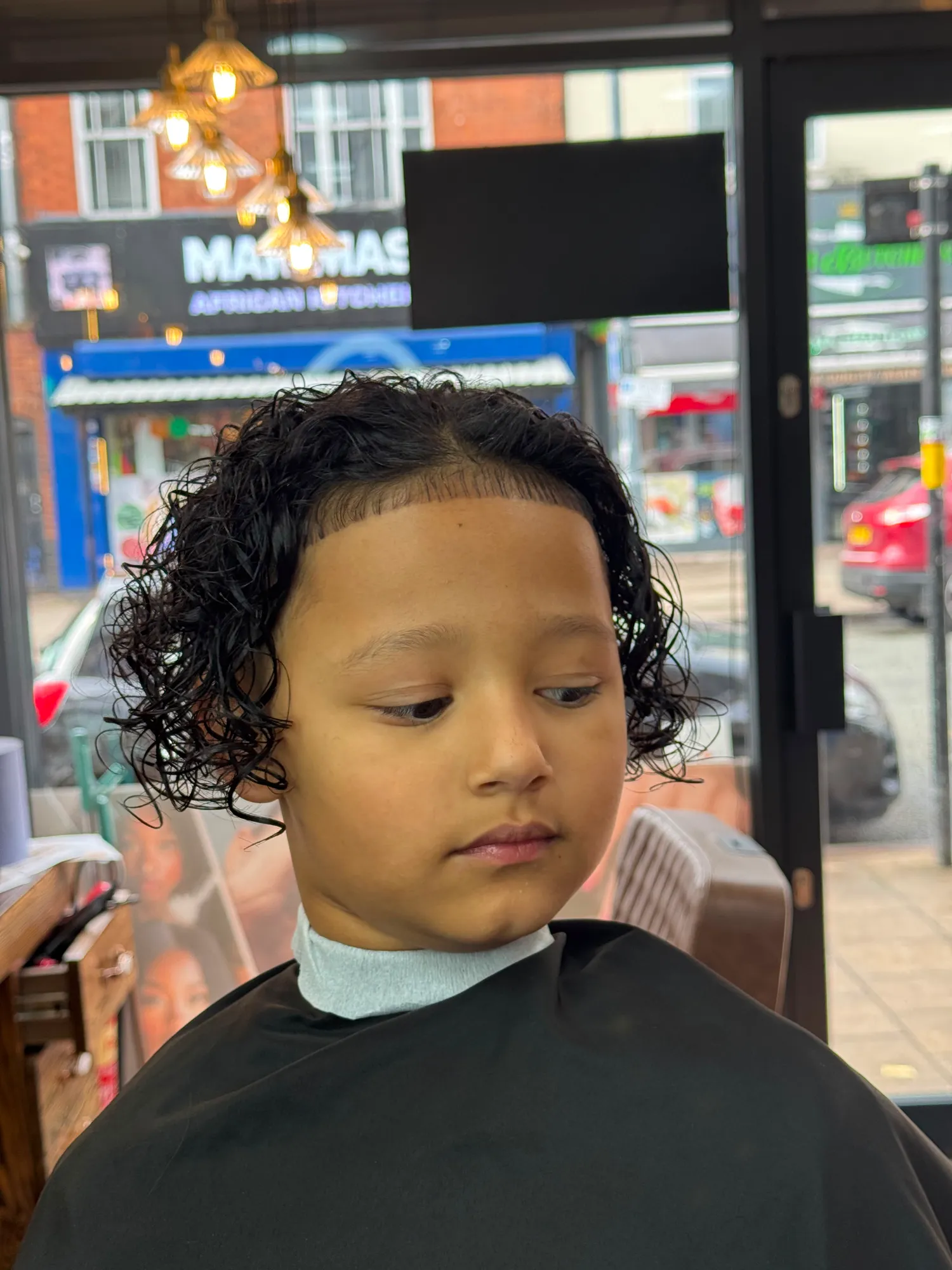Child's curly cut with a line-up
