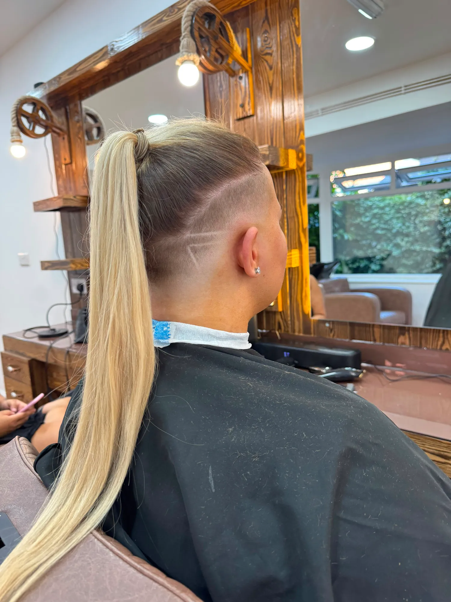Undercut design and ponytail, side view