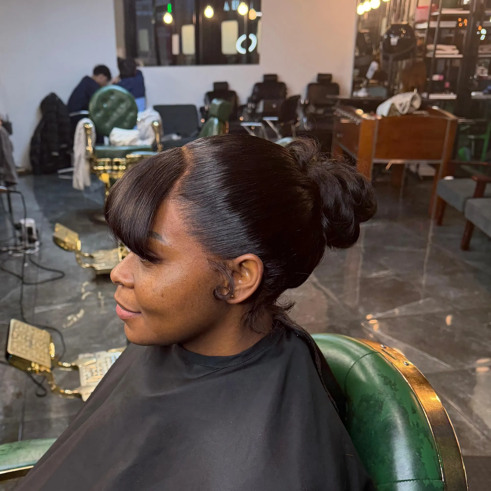 Sleek bun with a swooped fringe