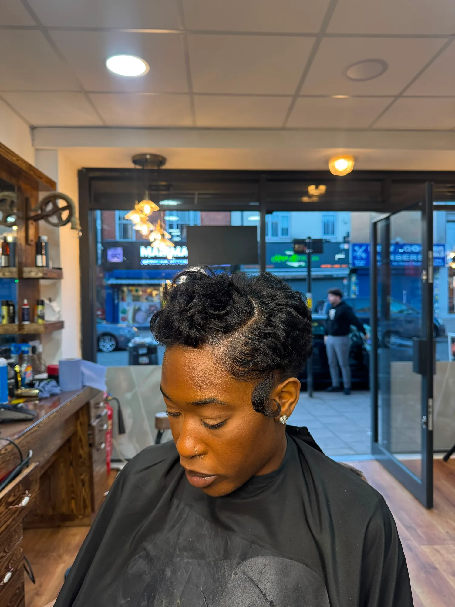 Short pixie cut styled with finger waves