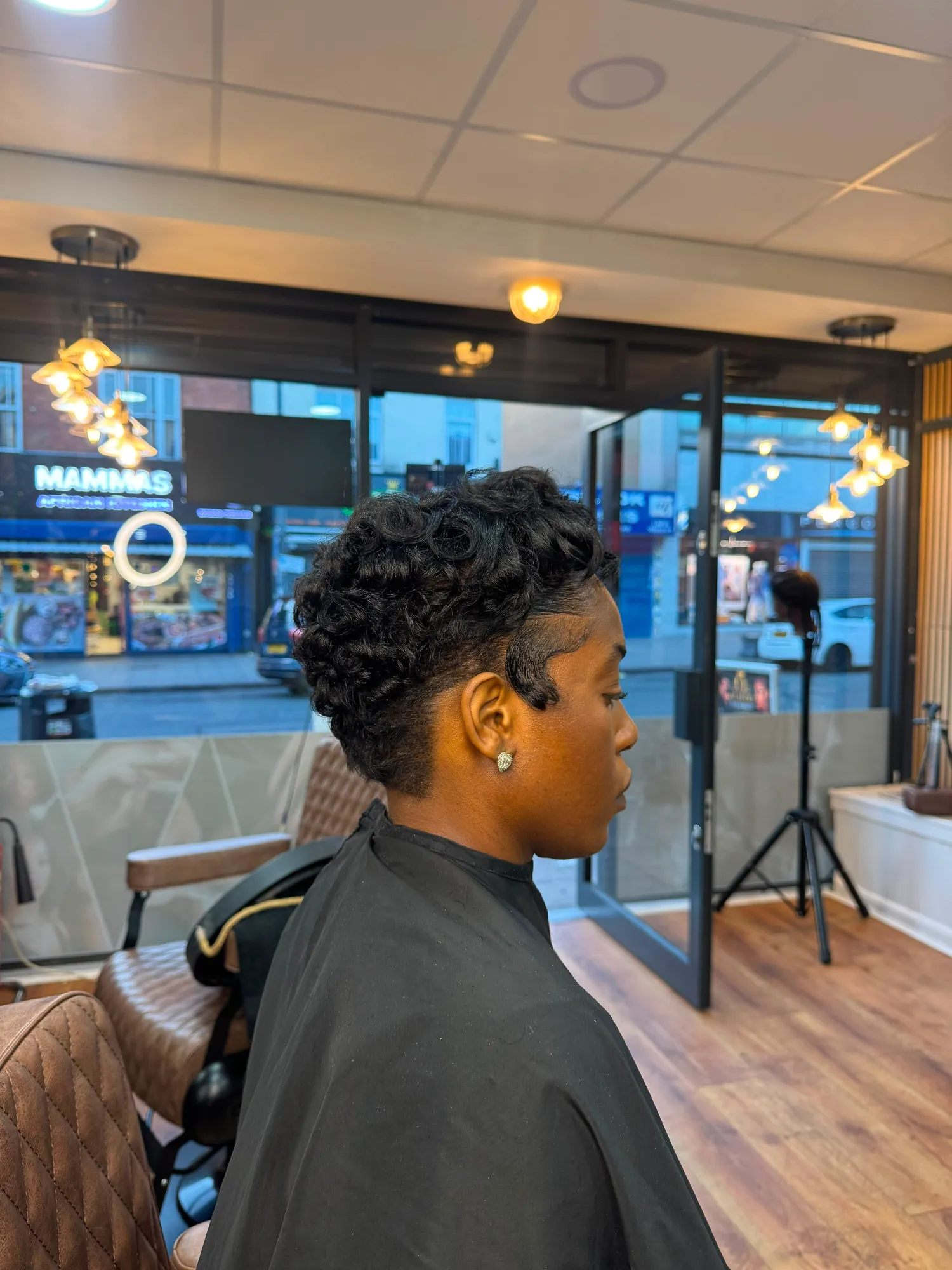 Short tapered cut with a curled crown