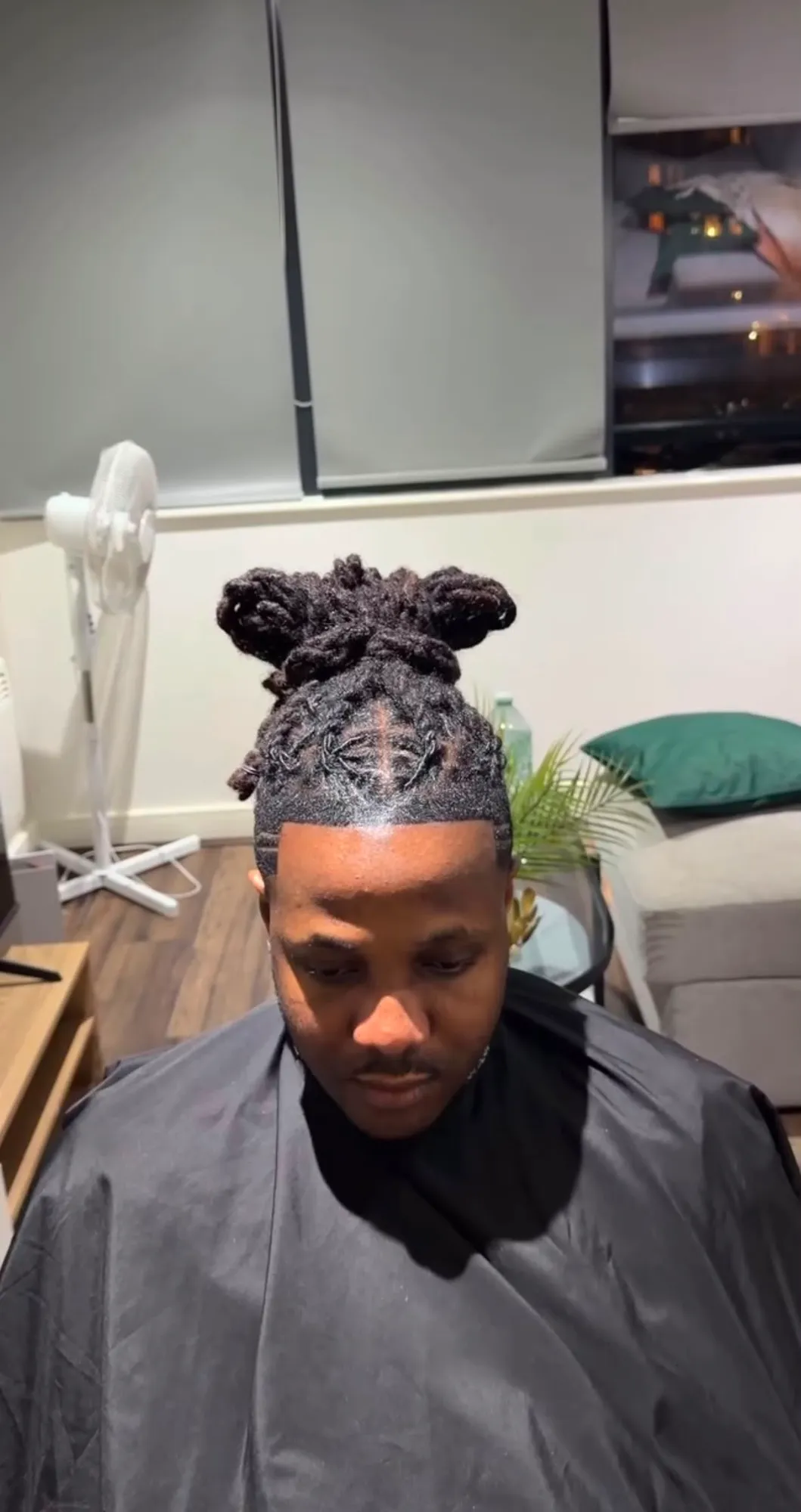 Men's locs styled into knots with a crisp line-up