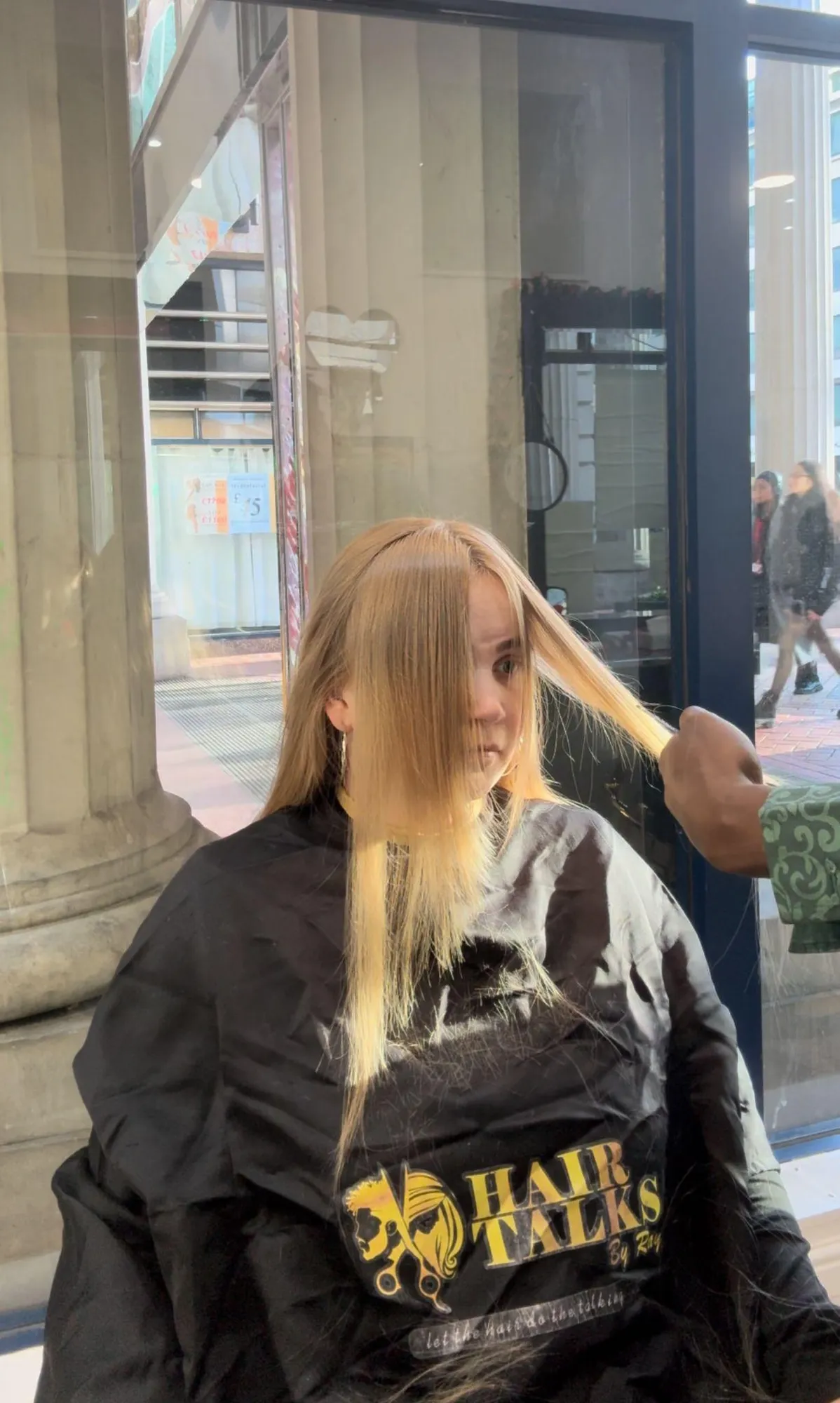 Blonde extensions being blended and styled